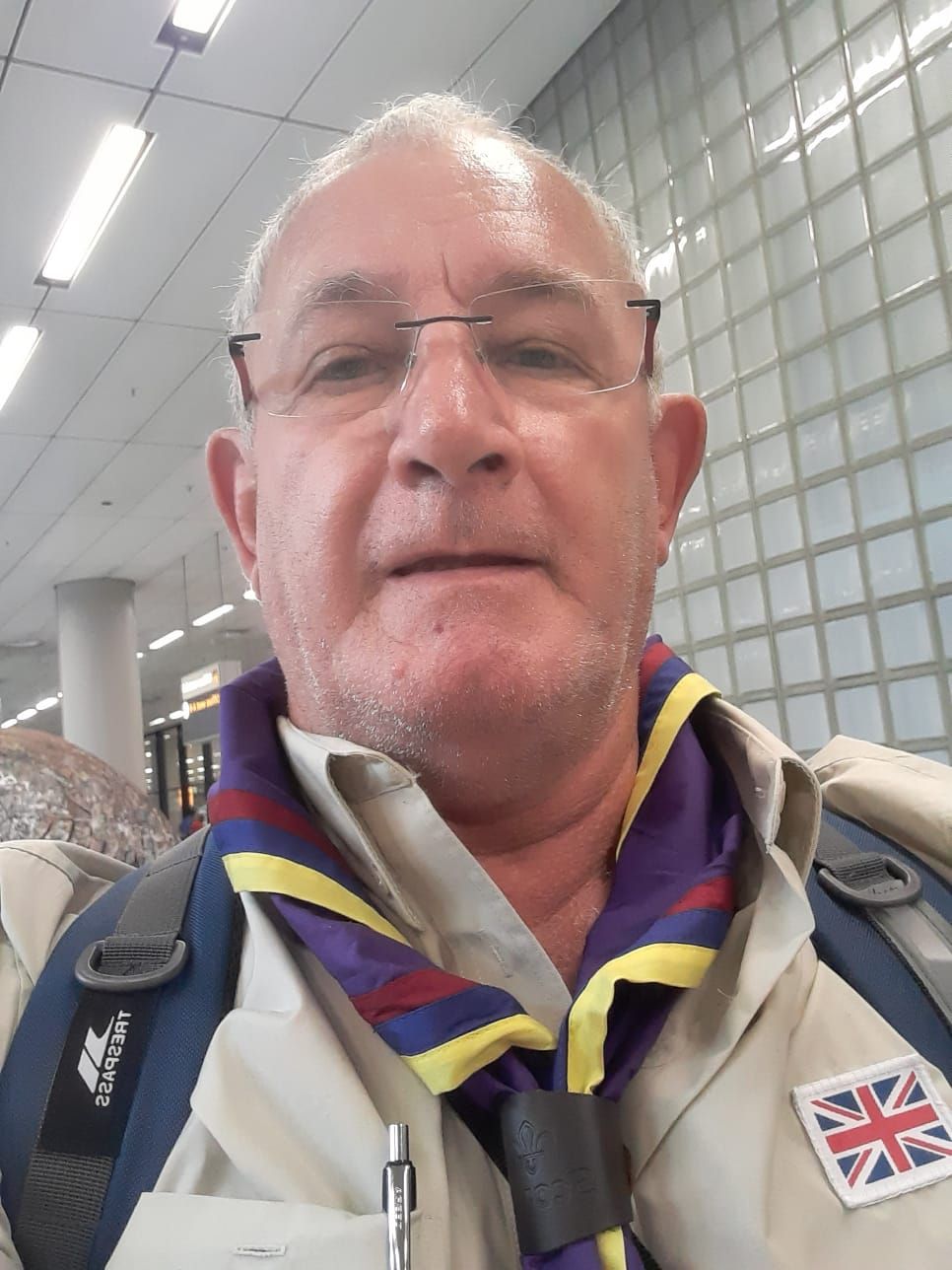 A man wearing glasses and a scarf with the british flag on it