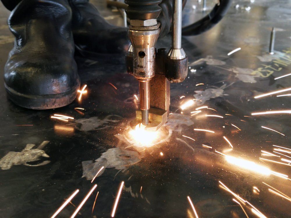 A Machine Is Cutting a Piece of Metal with Sparks Coming out Of It — Mayric Engineering in  Old Bar, NSW