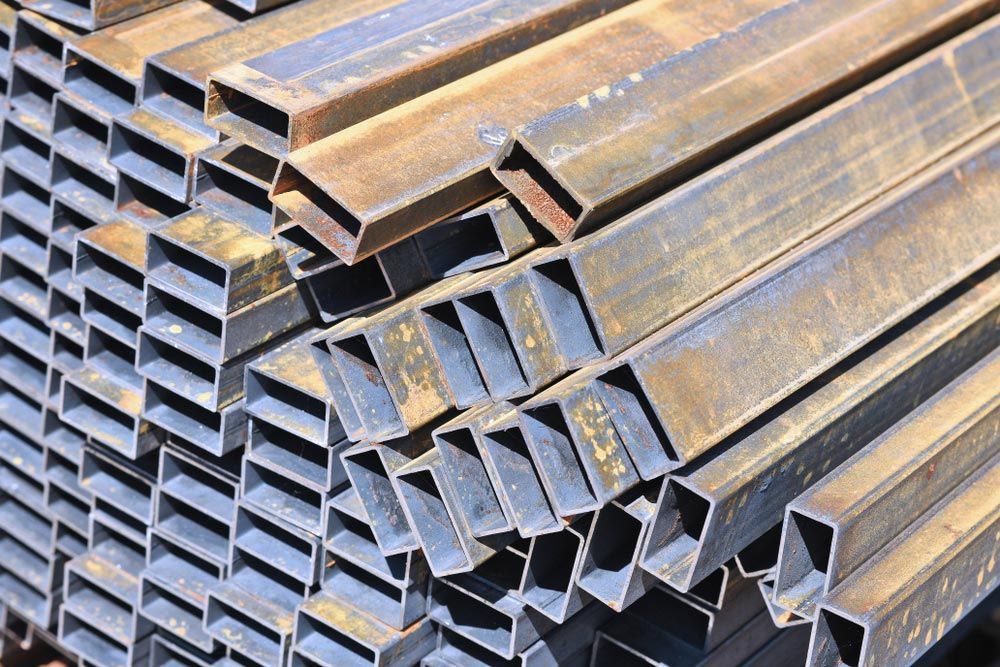 Pile of Metal Pipes Stacked on Top of Each Other — Mayric Engineering in Taree, NSW