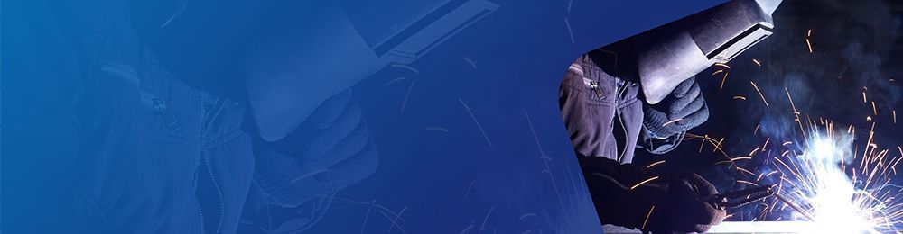 Person is Welding a Piece of Metal on a Blue Background — Mayric Engineering in Taree, NSW