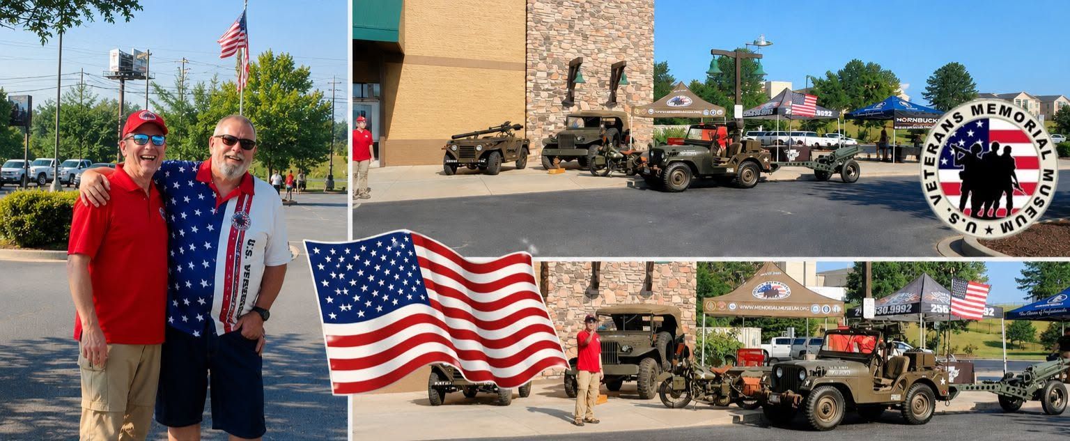 Two men posing by a U.S. flag near military vehicles at a brick building