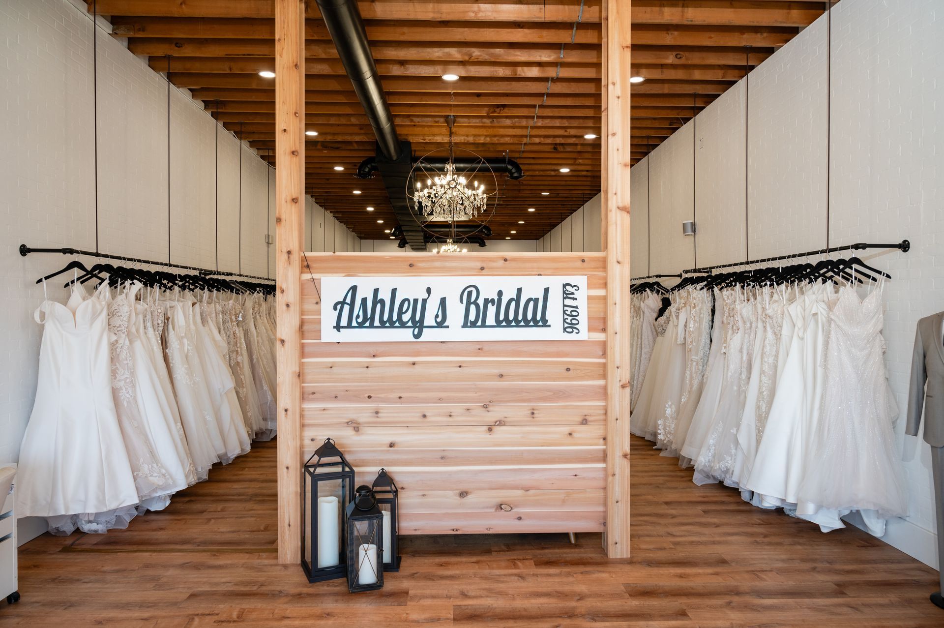 A store filled with lots of wedding dresses and a sign that says ashley 's bridal.