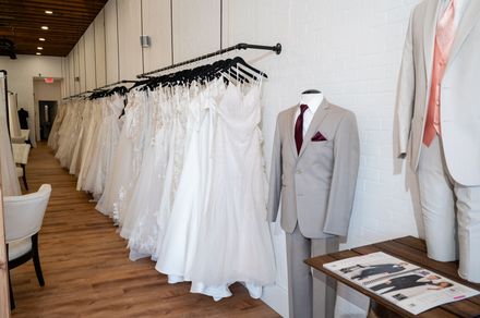 A store filled with lots of wedding dresses and suits.