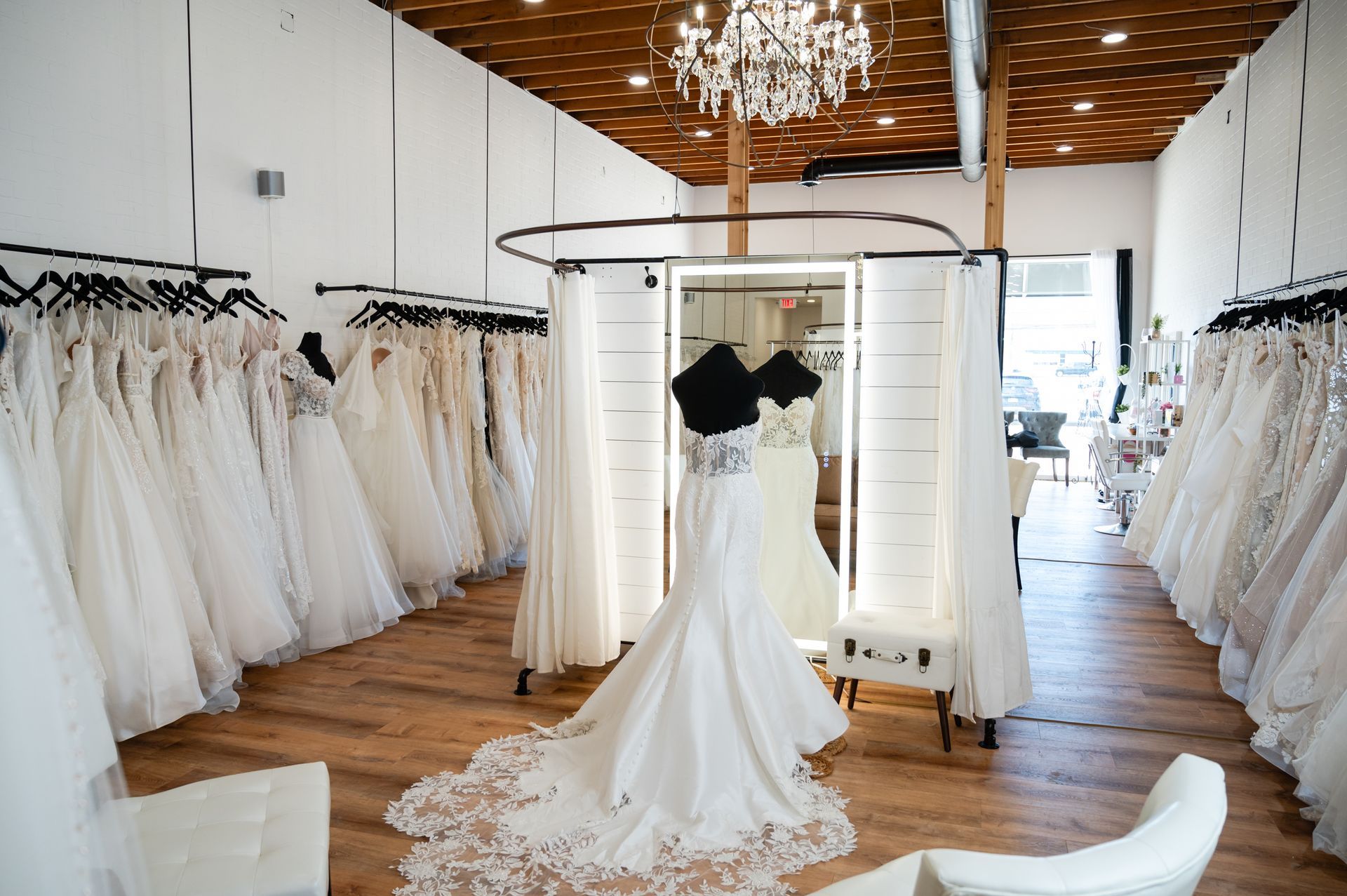 A wedding dress is hanging in a bridal shop.
