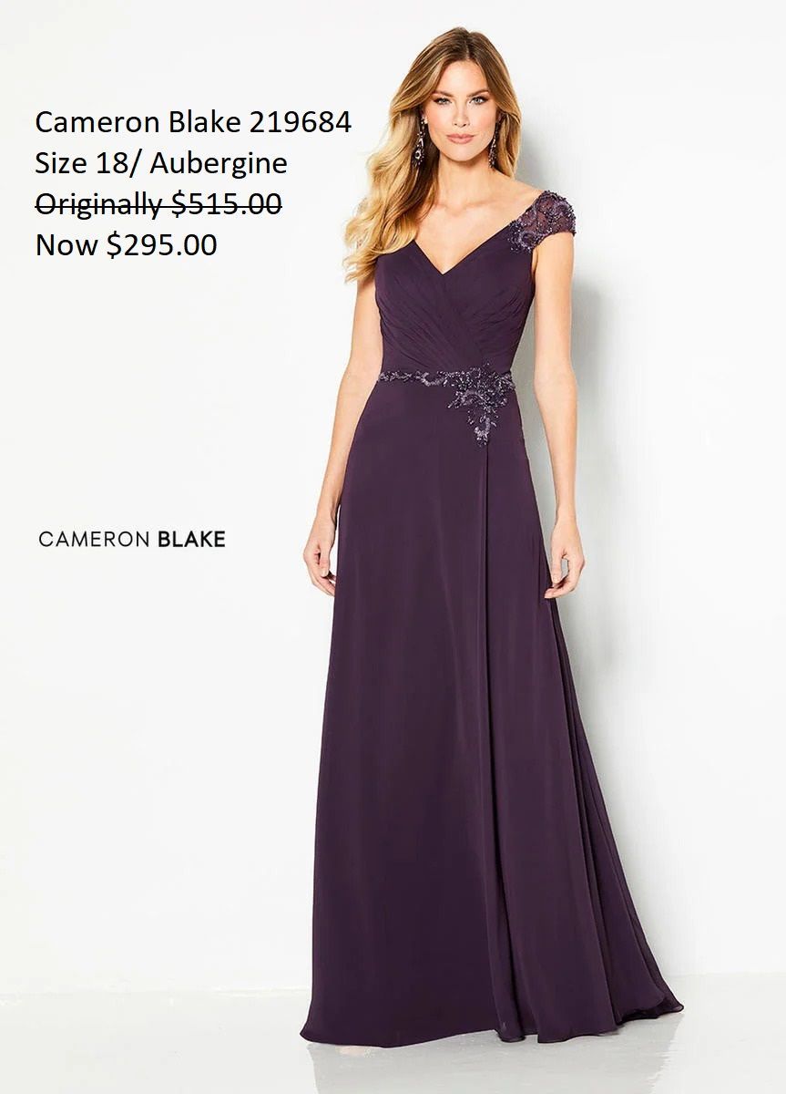 A woman is wearing a purple mother of the bride dress.