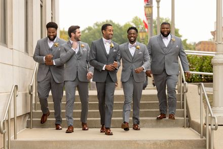 A group of men in suits are walking down a set of stairs.