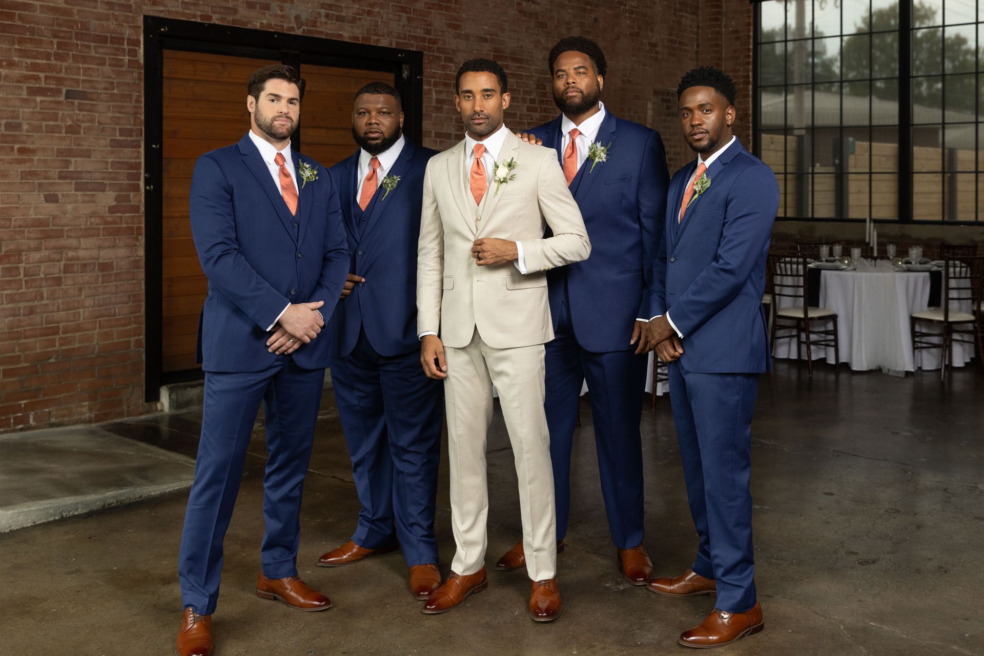 A group of men in suits and ties are posing for a picture.
