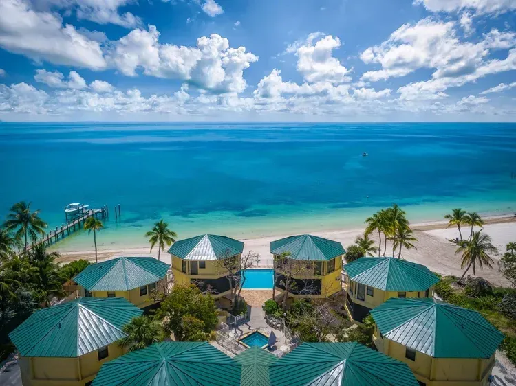 aerial view closer to beach front with pool in sight at Coco Plum Beach and Tennis Club and Marina in the Florida Keys