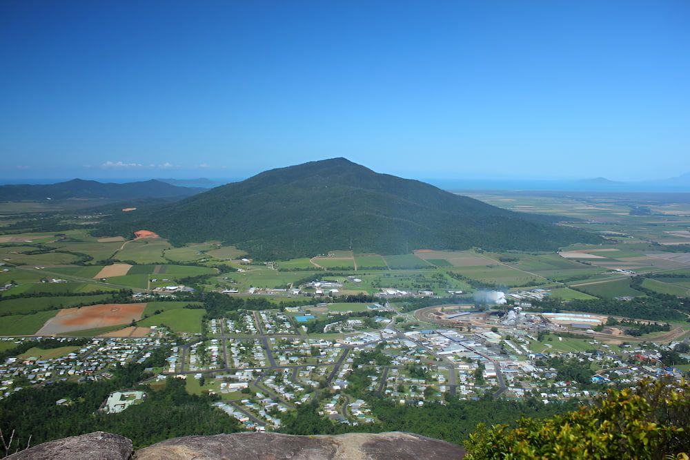 Town View With a Large, Green Mountain — Greenaway Green Waste Removal in Tully, QLD