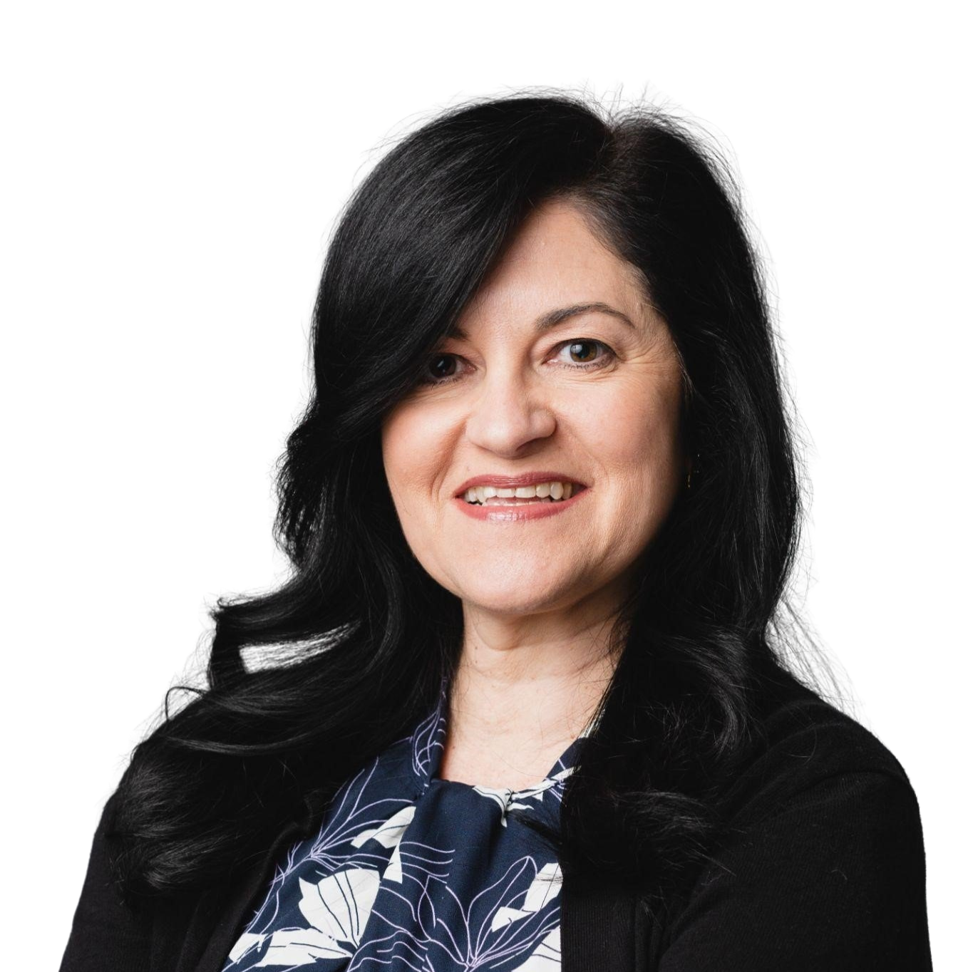 Woman with dark hair smiles, wearing a floral top and black sweater.