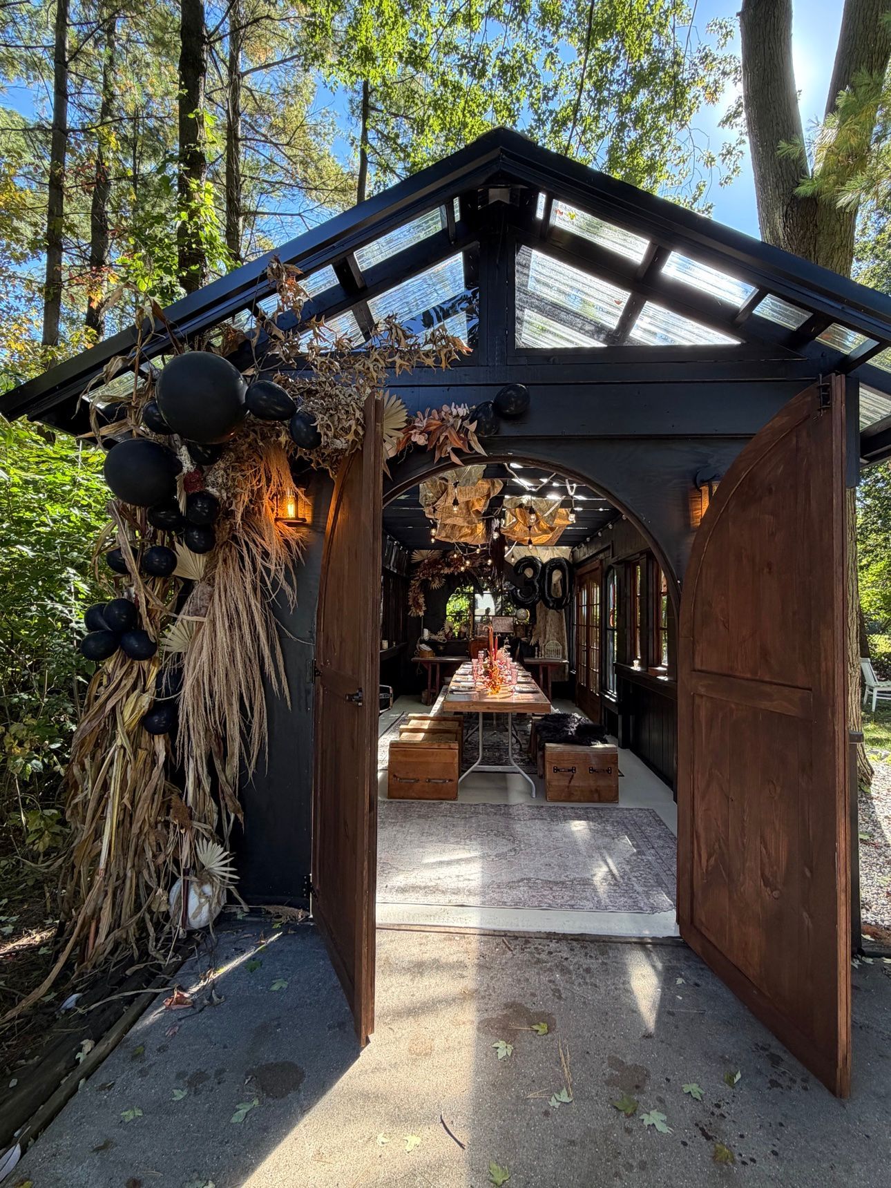 Black greenhouse decorated for birthday at night