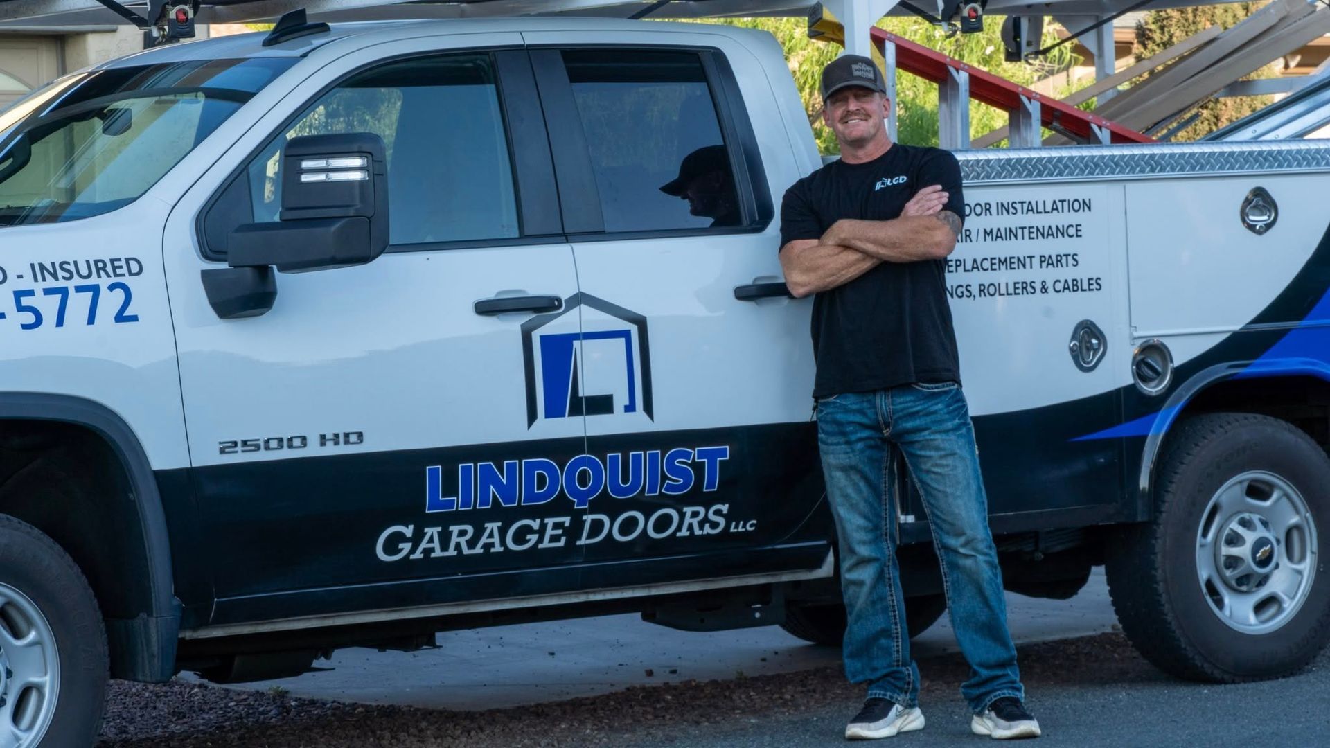 Man standing next to a white service truck with 