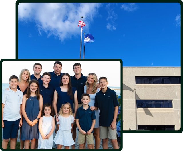 Family portrait with building and flags in background.