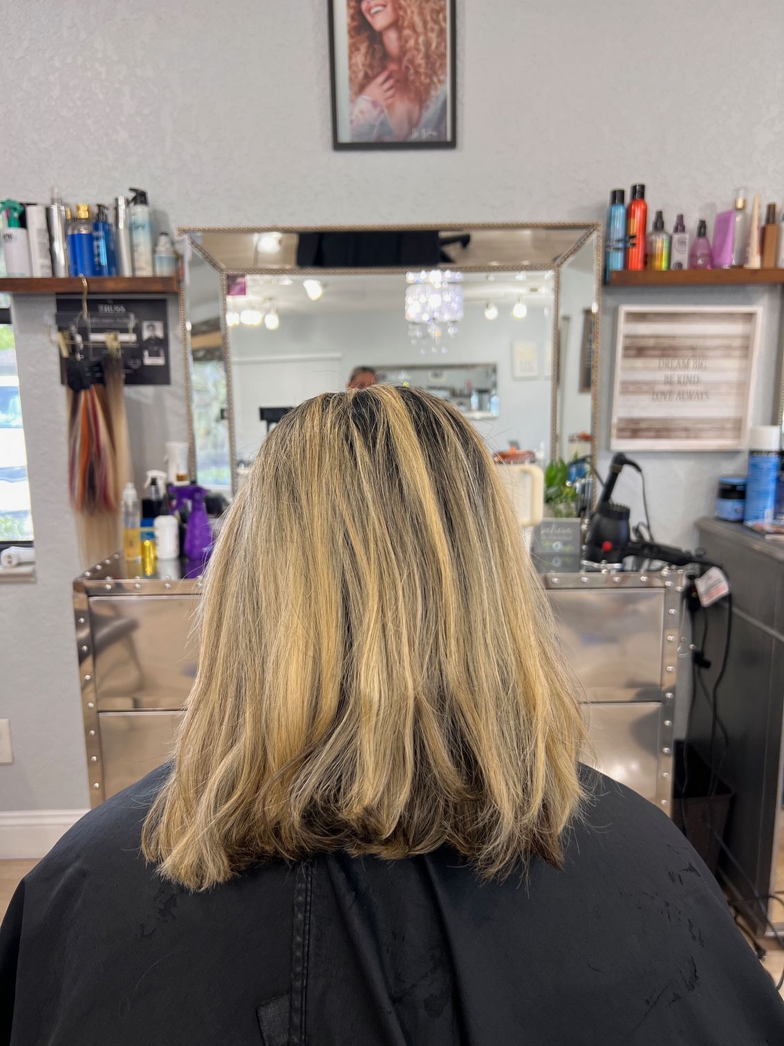 A woman is getting her hair cut in a salon