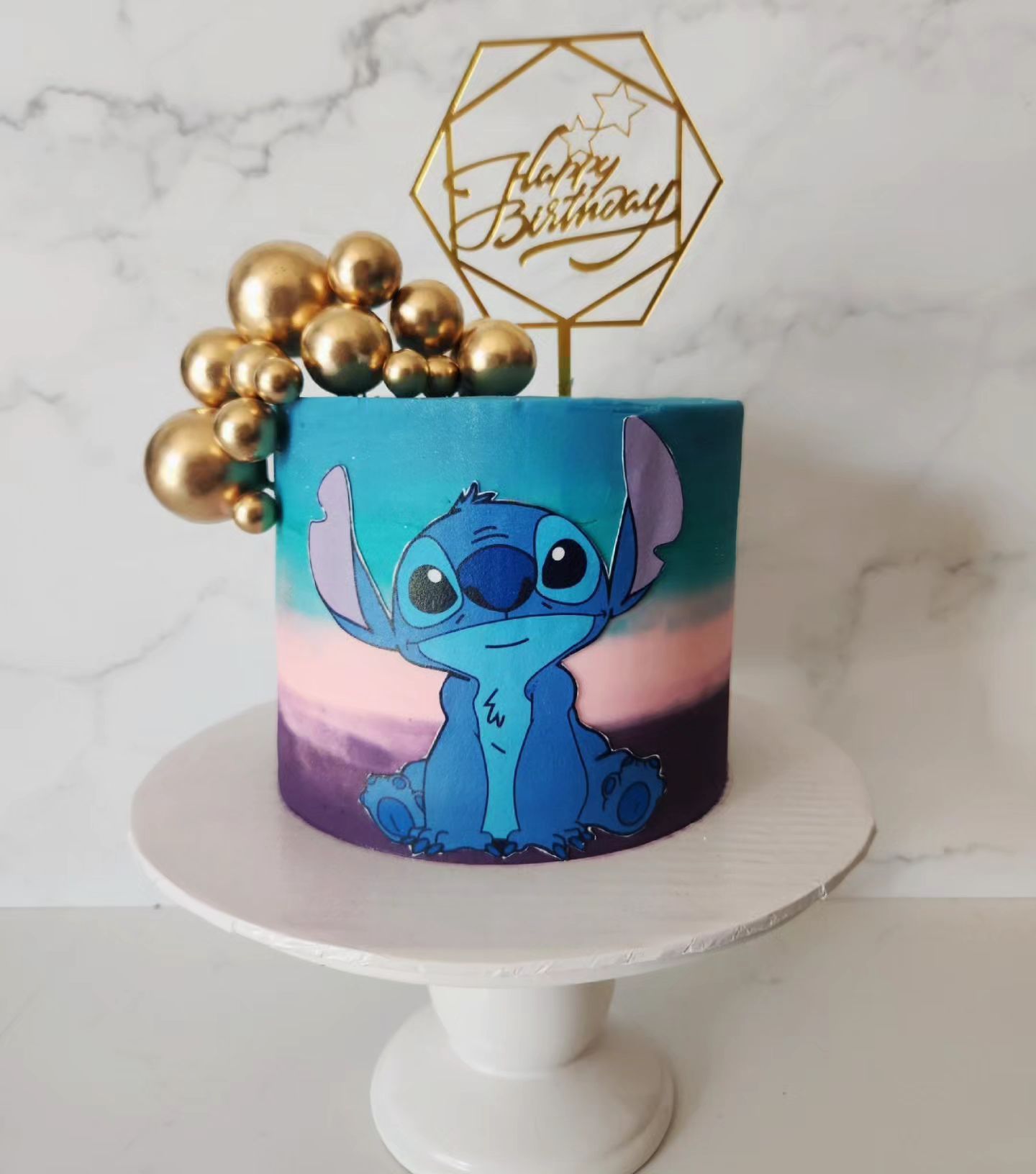 Stitch birthday cake with gold accents, and a gold