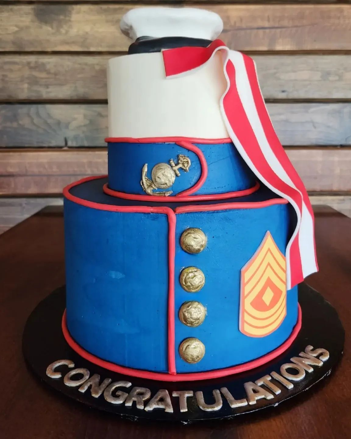 Cake decorated as a U.S. Marine uniform. Blue and white with gold accents, red trim, and