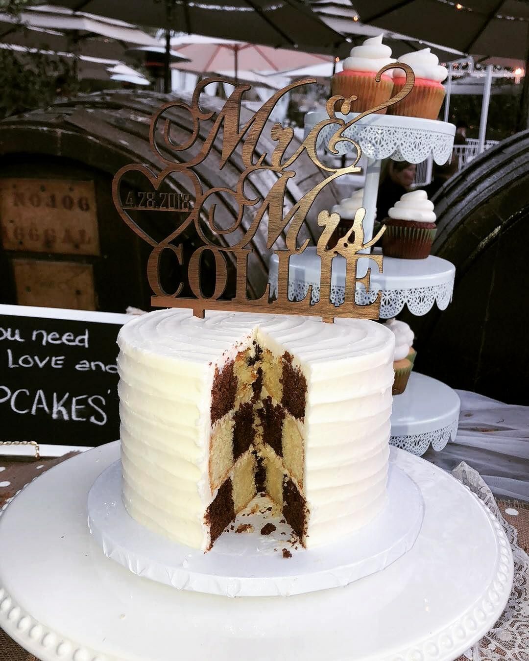 Cake with a checkered interior, topped with a wooden