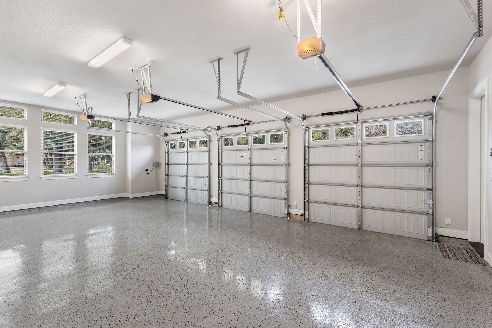 A large empty garage with a lot of garage doors.