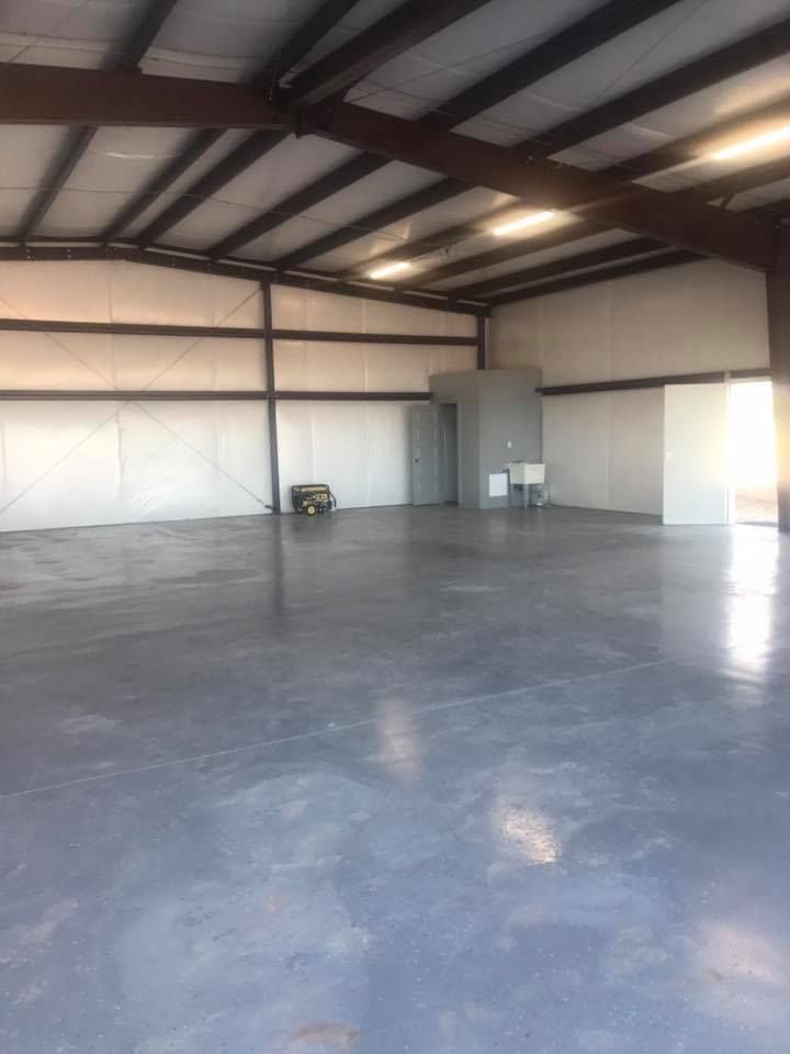 A large empty warehouse with a concrete floor