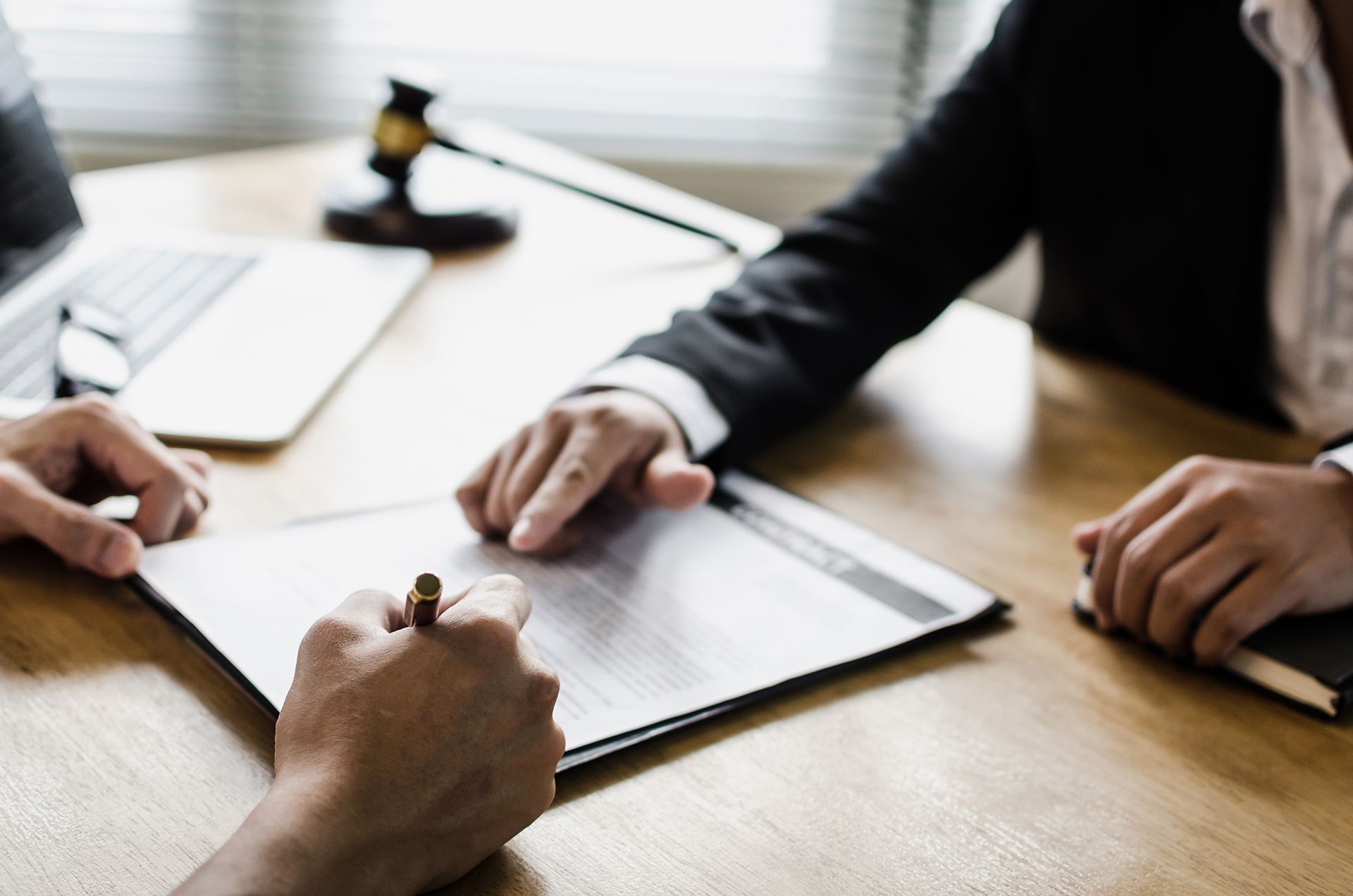 Attorney With His Client Signing a Document