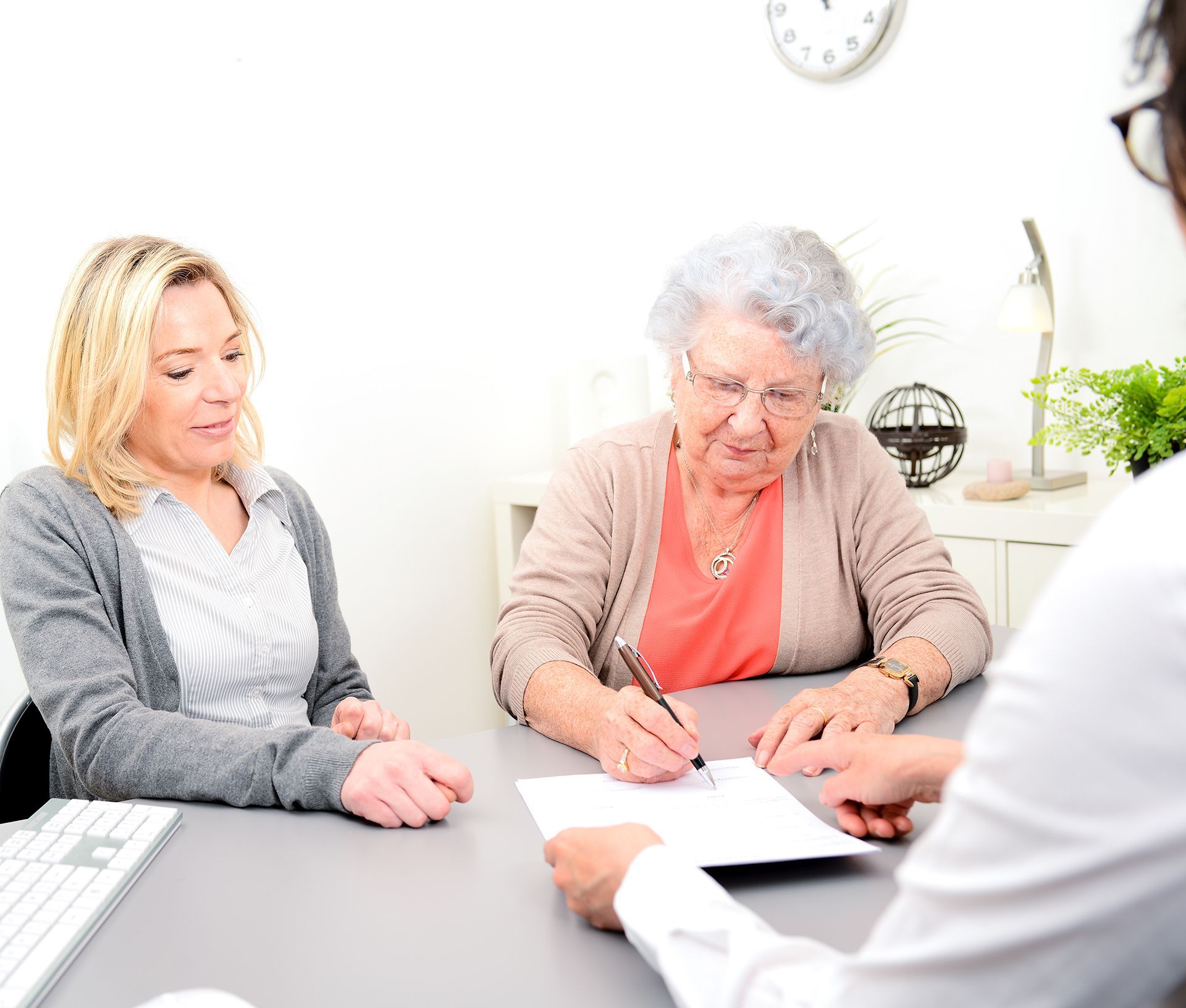 Senior Woman Signing a Document