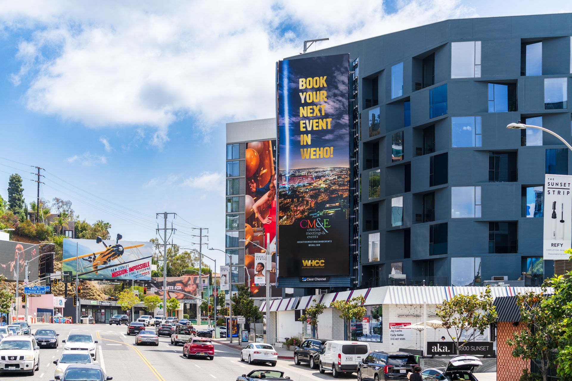 Urban streetscape with a hotel, billboards, and traffic near the Sunset Strip