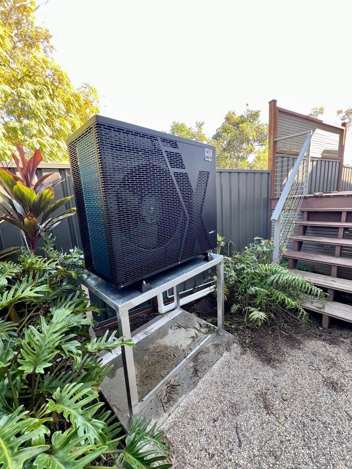 A Black Outdoor Heat Pump on a Metal Stand — Cascade Pool & Spa Centre in Macksville, NSW