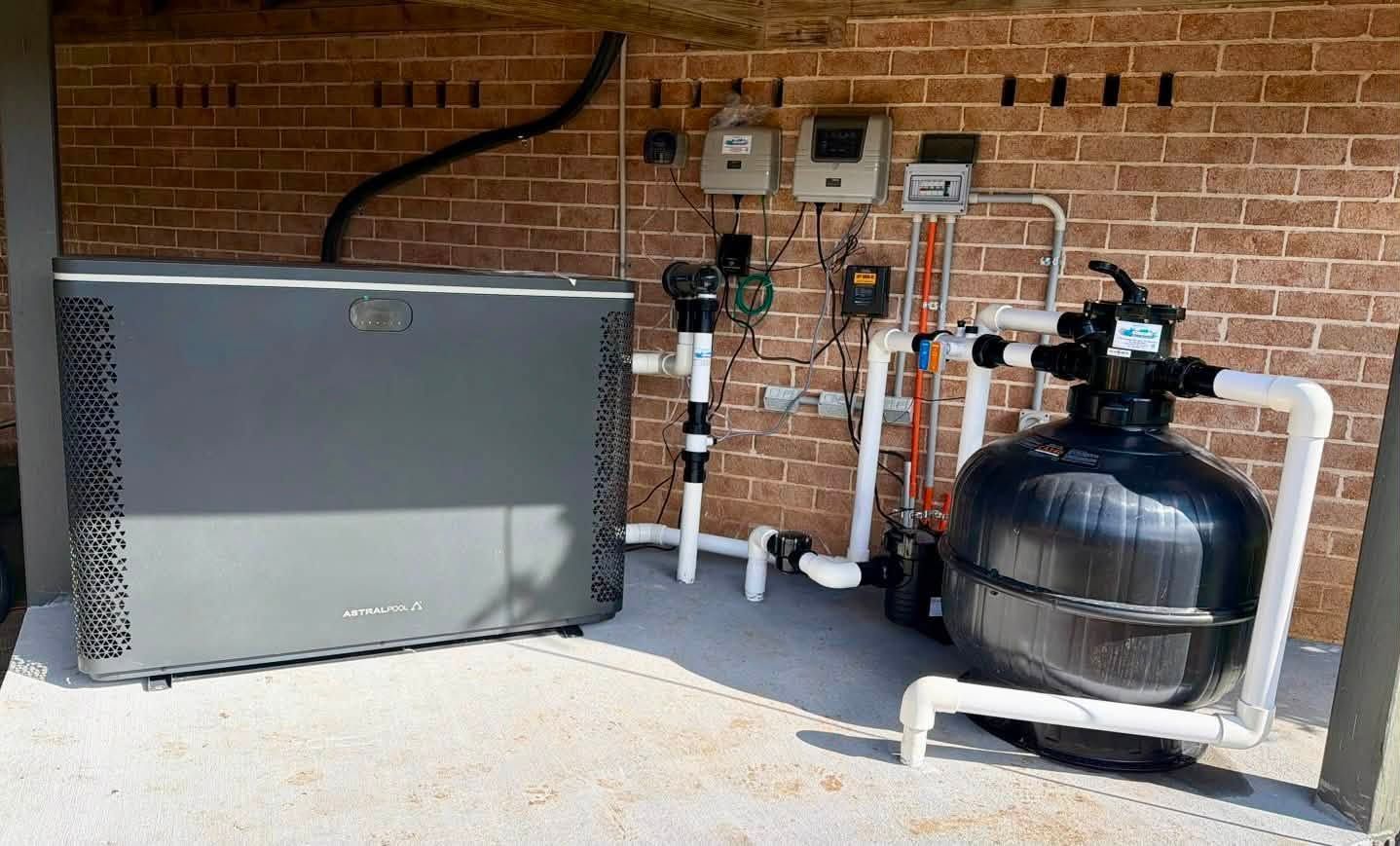 Outdoor HVAC Equipment Beside a Brick Wall, Including a Large Gray Unit — Cascade Pool & Spa Centre in Port Macquarie, NSW