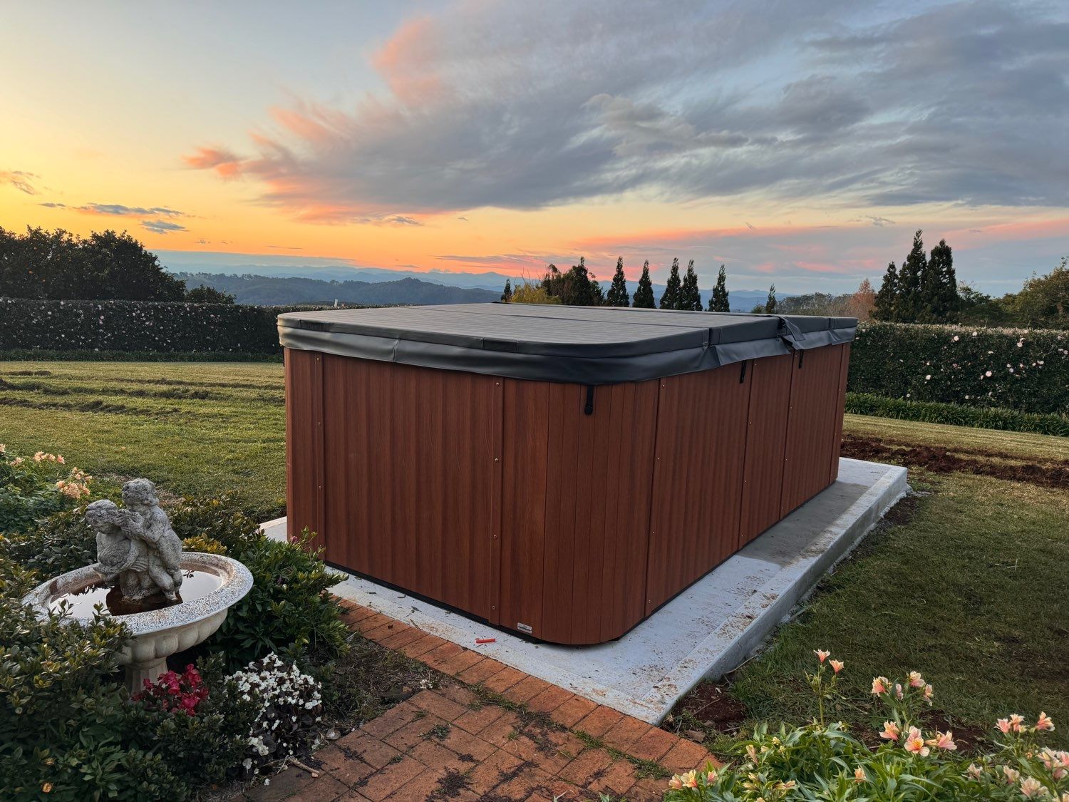A Poolside Corner With Palm Leaf Shadow on Textured Concrete Next to Rippling Blue Water — Cascade Pool & Spa Centre in Port Macquarie, NSW