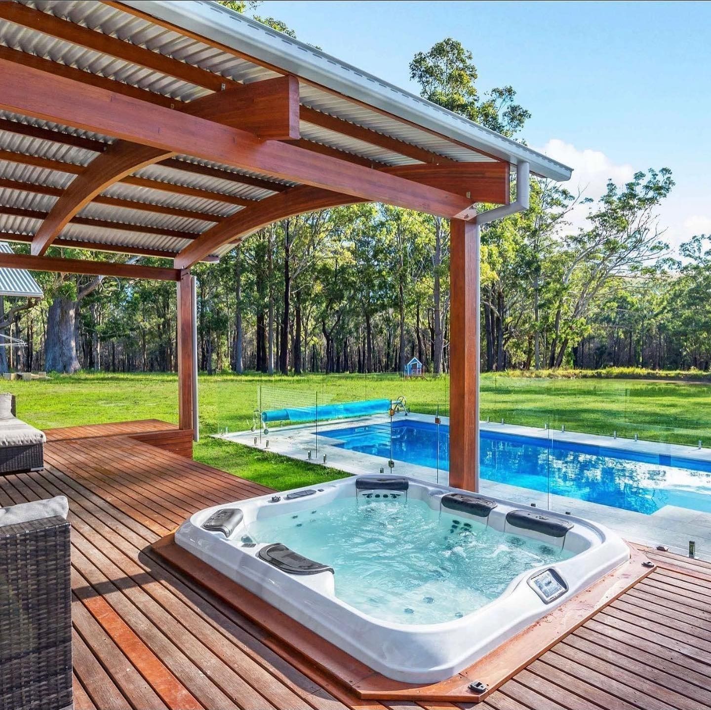 A Hot Tub and Pool on a Wooden Deck Under a Covered Patio — Cascade Pool & Spa Centre in Port Macquarie, NSW
