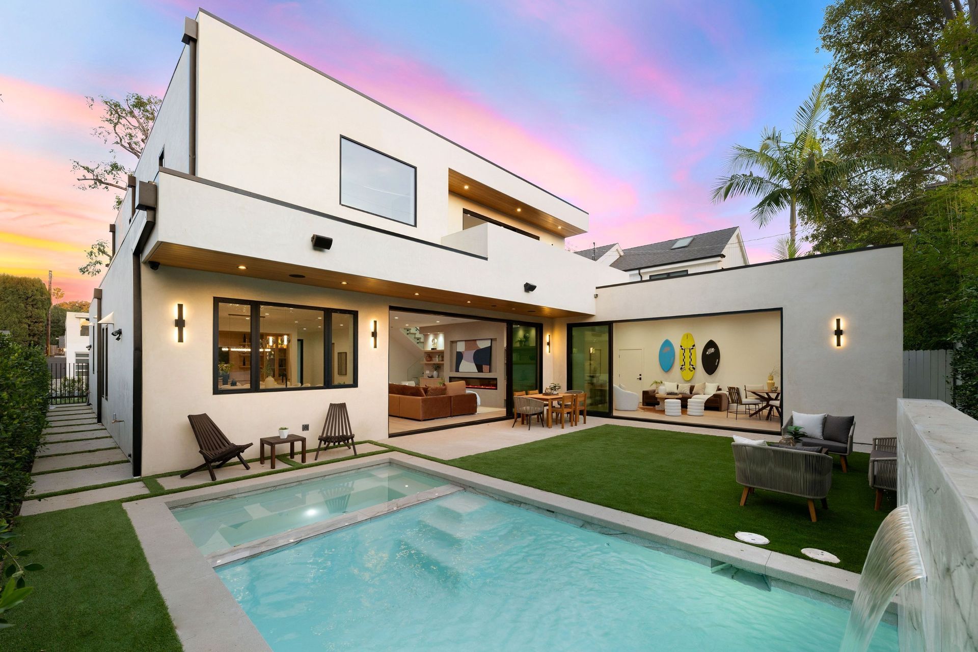 Pool in front of a house with clear windows and green lawn — Cascade Pool & Spa Centre in Port Macquarie, NSW