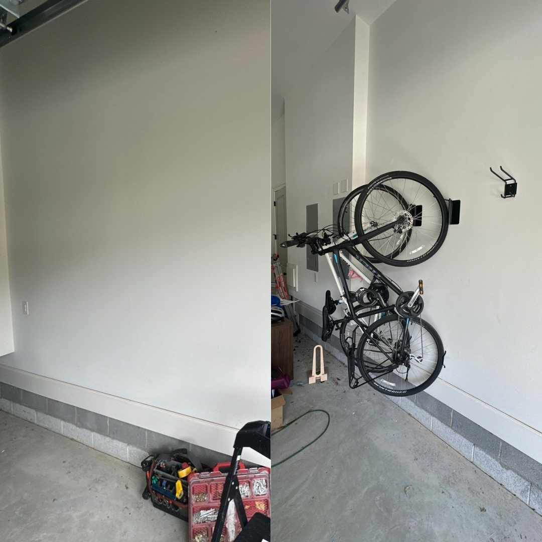 Garage interior: white walls, bike mounted on wall rack, tools on the floor.