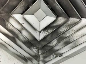 Abstract grayscale geometric pattern of layered diamond shapes and concentric ridges