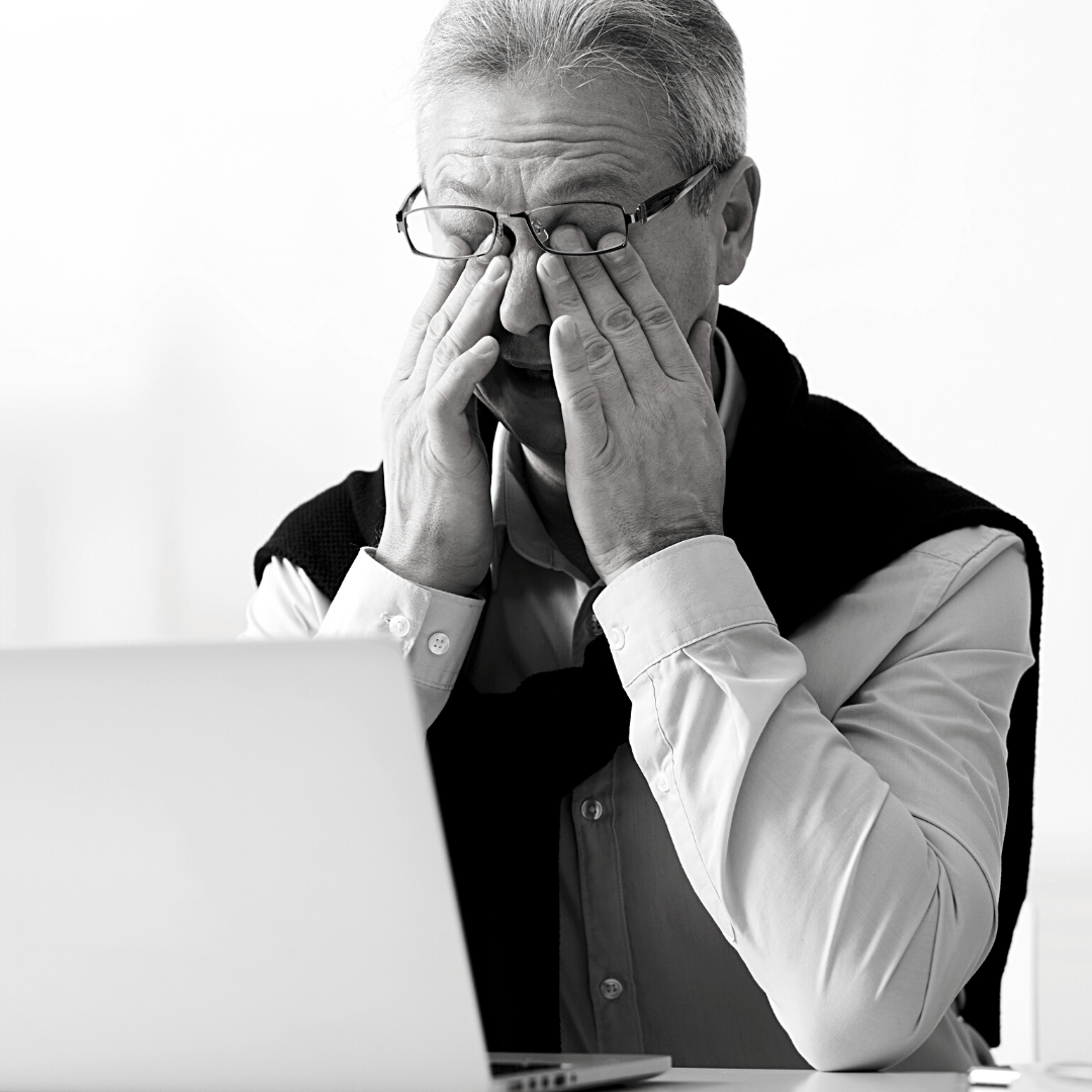 tired man in front of laptop
