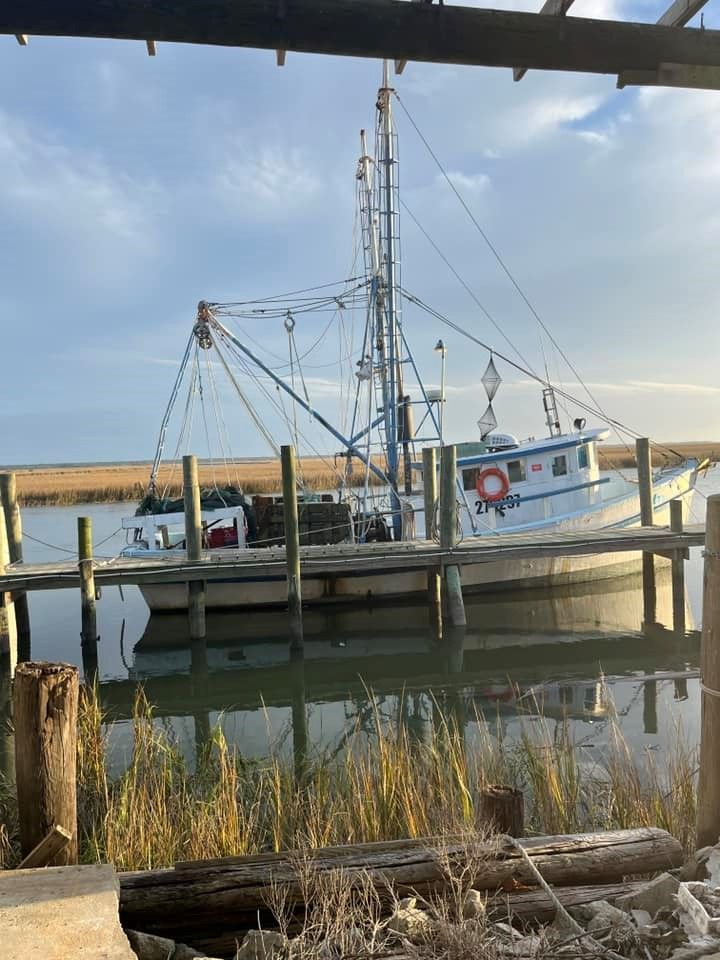 A boat is docked at a dock in the water.
