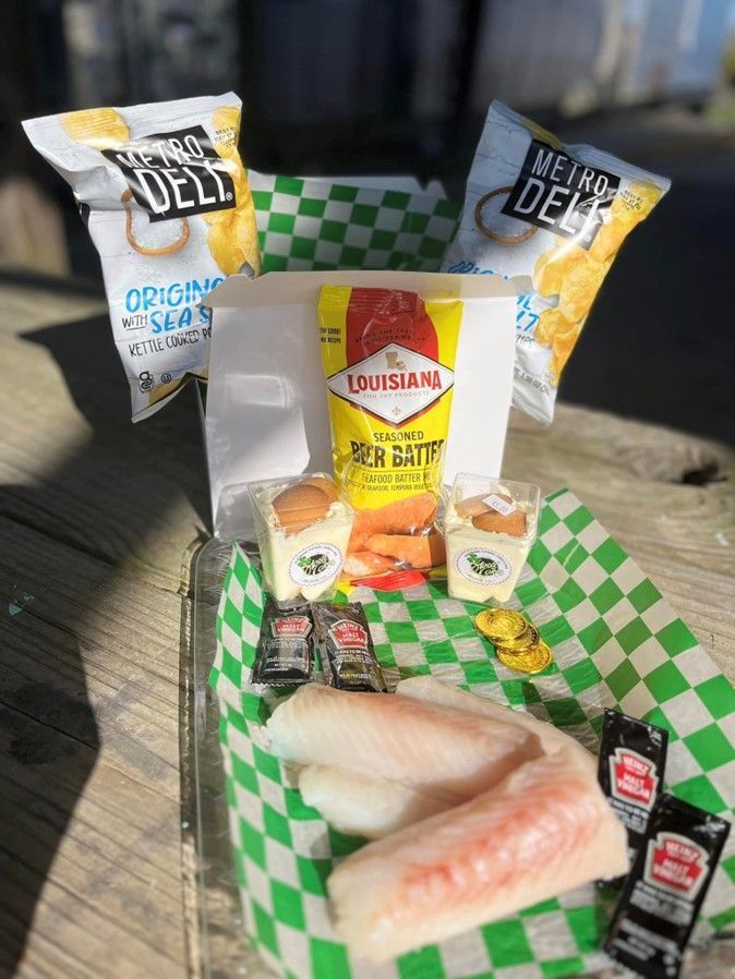 A plate of food with chips and sauces on a table.