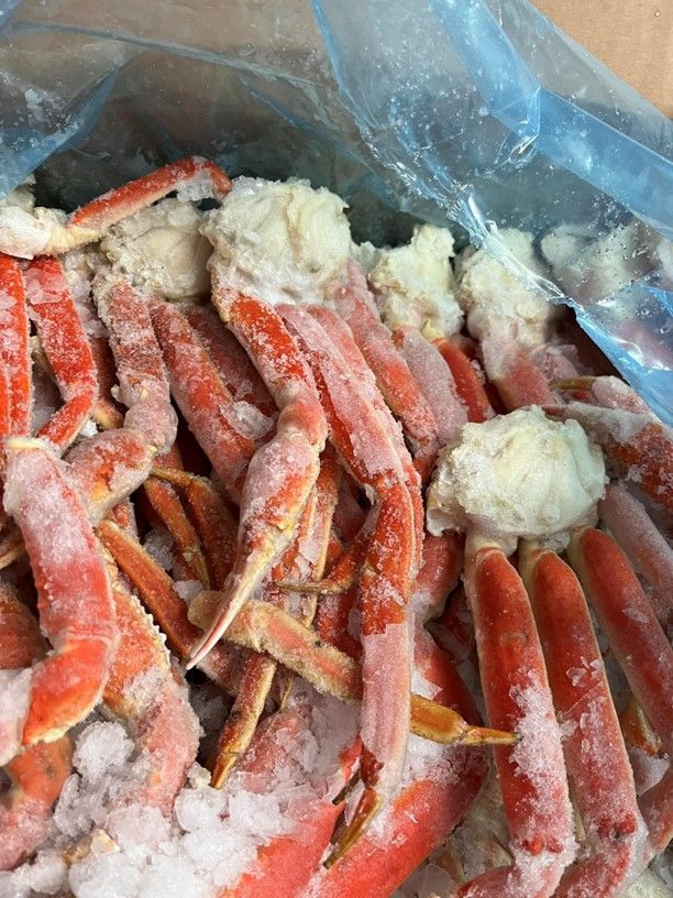 A bag of frozen crab legs is sitting on a table.