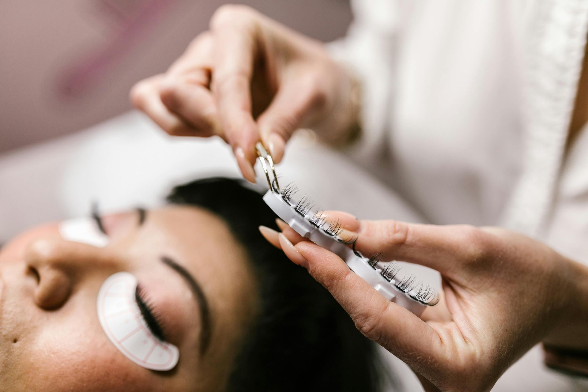 Woman receiving eyelash extensions at Esthetics by Sam Granger Indiana