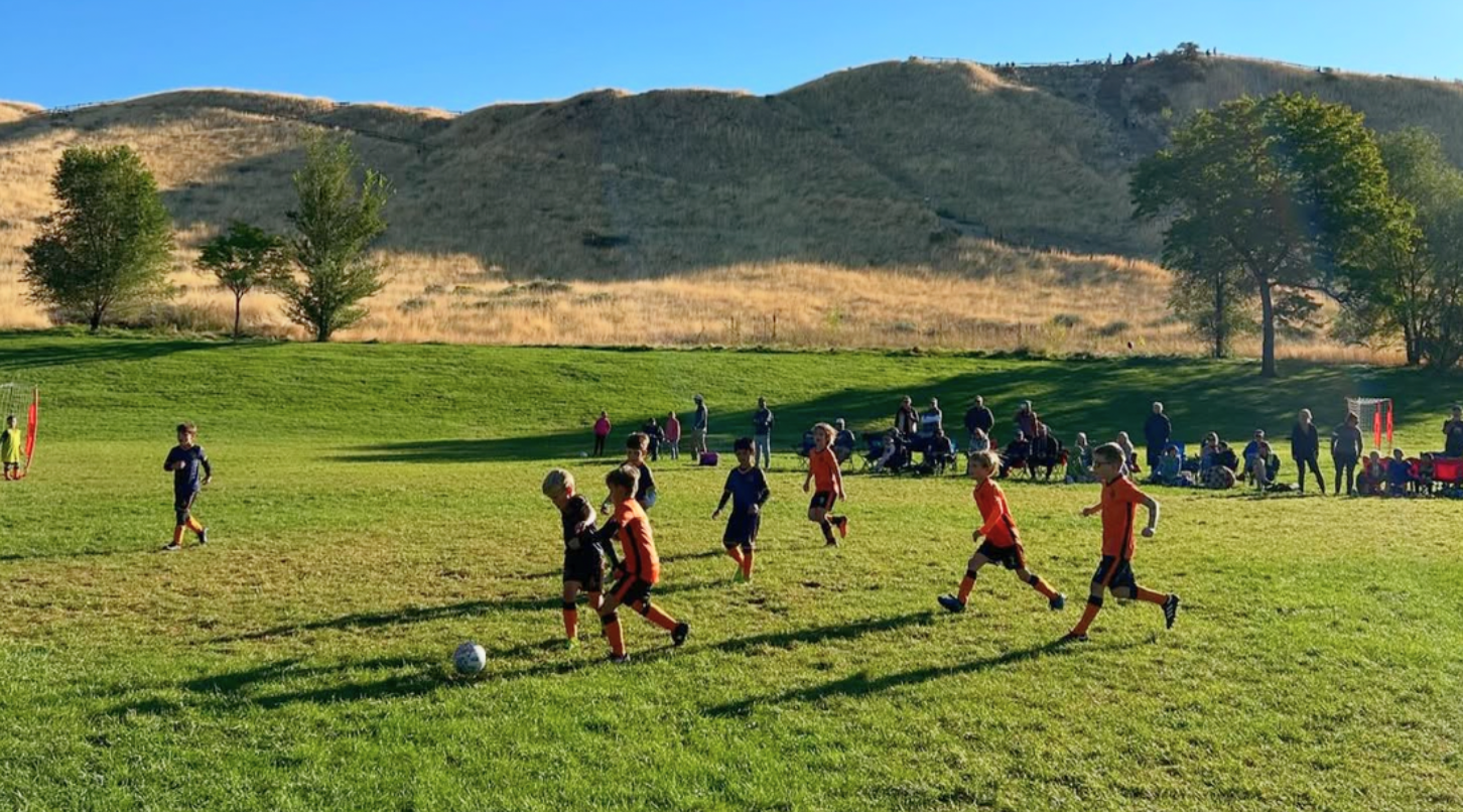 Youth soccer players competing during a School of Soccer game.