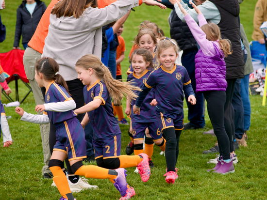 Families celebrating after a Boise Youth Soccer match.
