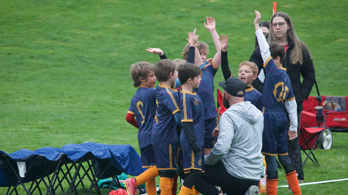 Boise School of Soccer players team huddle 