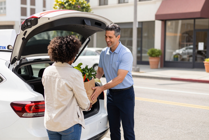 Taxi driver helping with grocery delivery in Los Angeles.