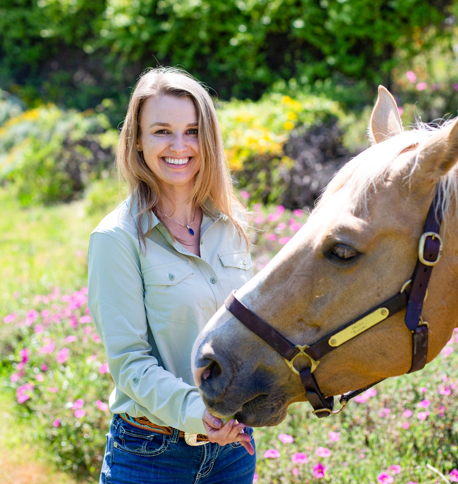 Woman giving a horse some food