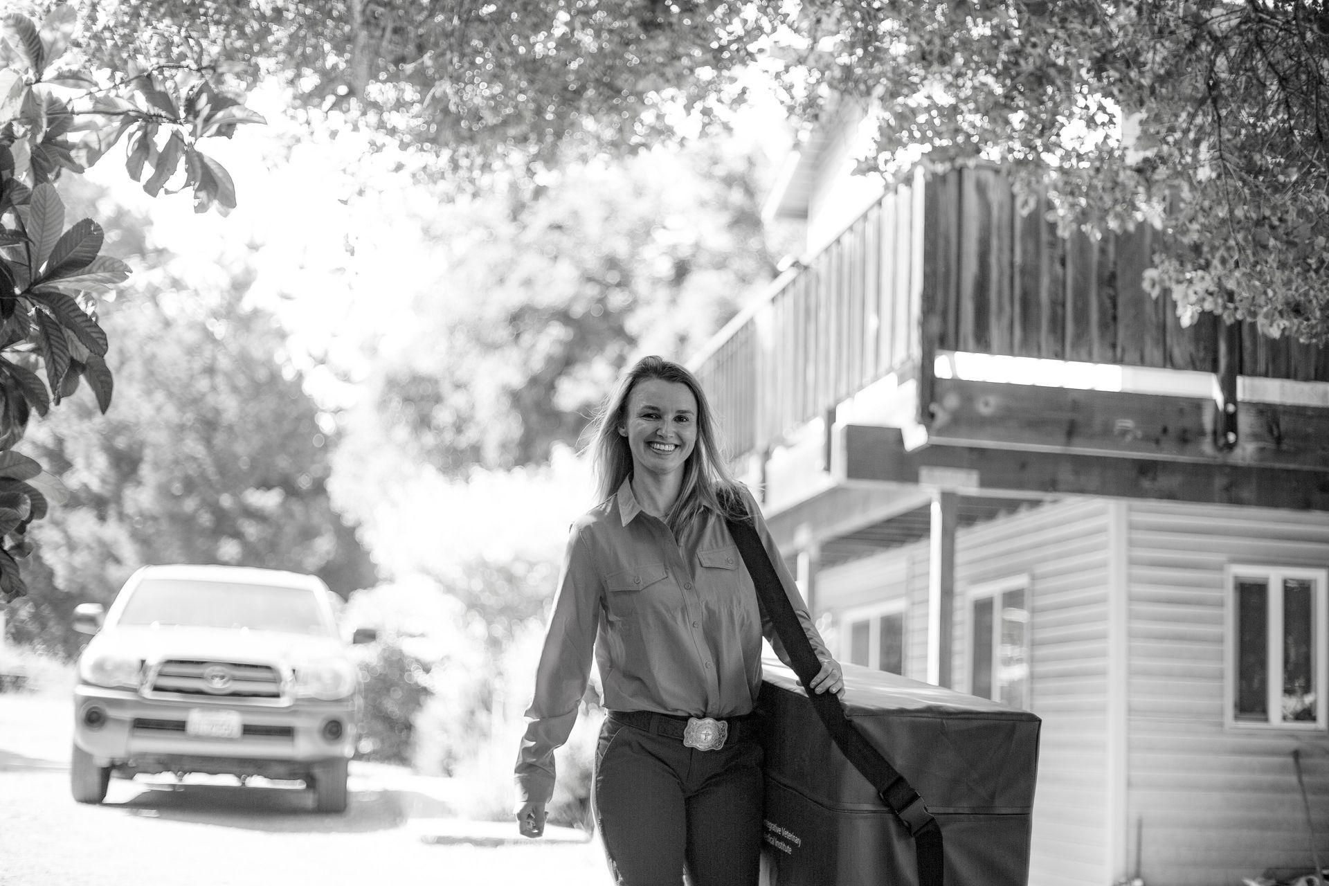 Woman walking carrying a large case