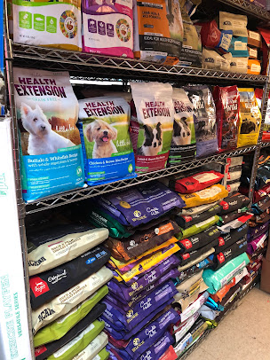 Store shelf stocked with assorted cleaning products and detergent bottles in various colors.