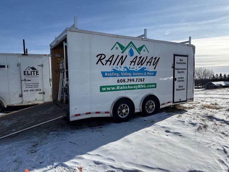 Two white trailers with branding for