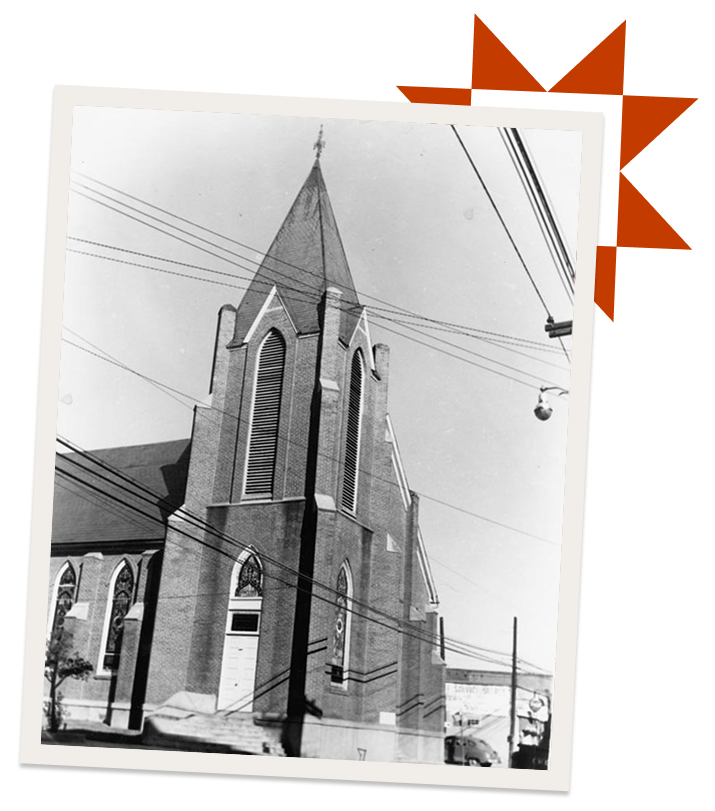 Black-and-white photo of a church steeple, framed on a white background with orange starburst accents.