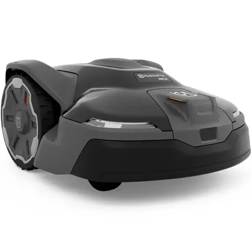 Compact gray robotic lawn mower with black wheels on a white background
