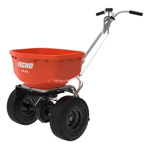 Red wheeled yard spreader with black tires and silver handle on a white background