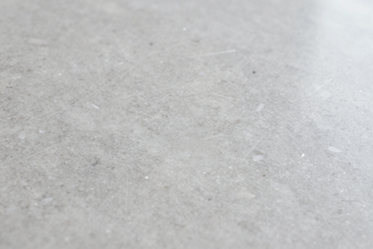 Fine scratches and dull sheen on an engineered quartz countertop